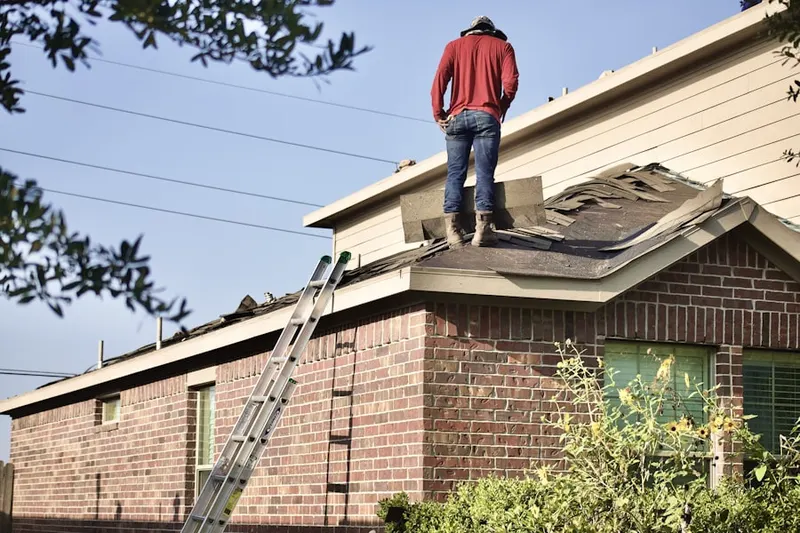 Professional roofer working on a residential roof in Briarforest